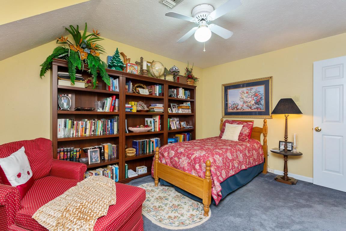2120 Cairo Bend Road Lebanon, TN 37087 - Photo 23 of 30 a bedroom with a bed a book shelf and a book shelf