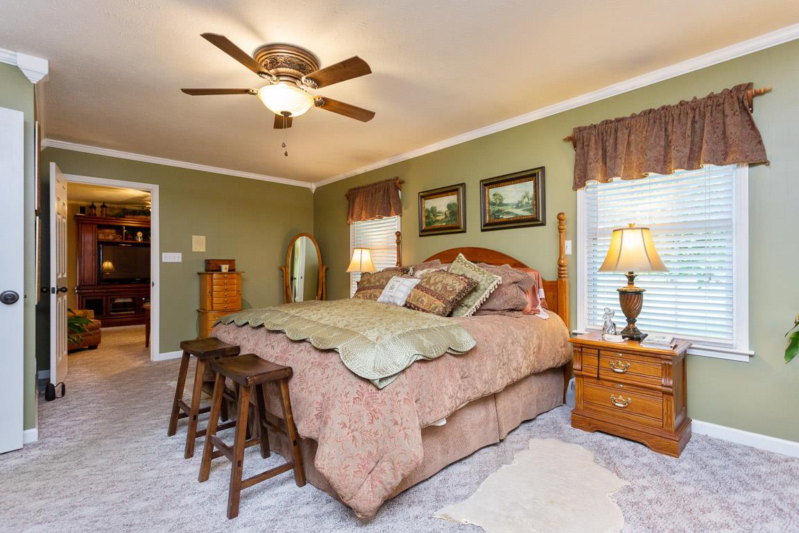 2120 Cairo Bend Road Lebanon, TN 37087 - Photo 7 of 30 a bedroom with a bed and dresser with mirror