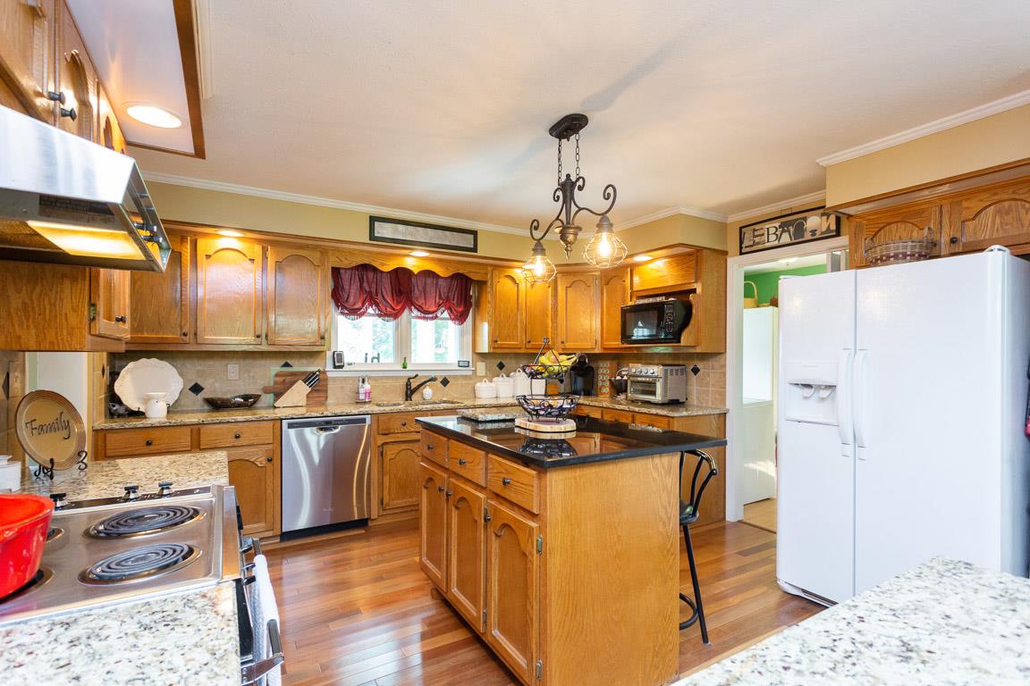 2120 Cairo Bend Road Lebanon, TN 37087 - Photo 10 of 30 a kitchen with stainless steel appliances granite countertop a sink stove and refrigerator