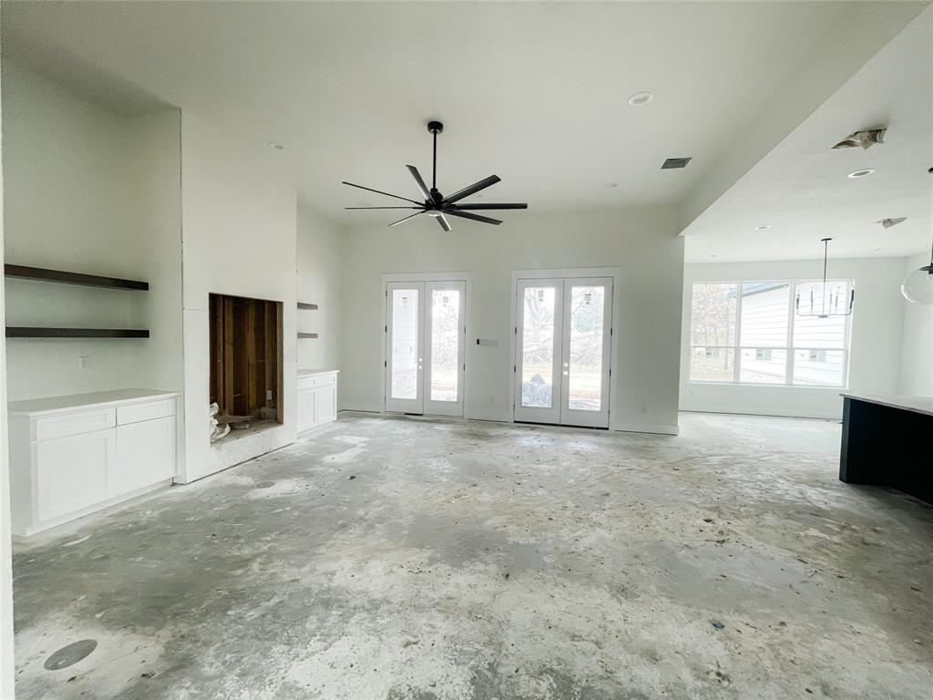 4072 County Road Cleburne, TX 76031 - Photo 17 of 20 a view of an empty room with a window and a kitchen