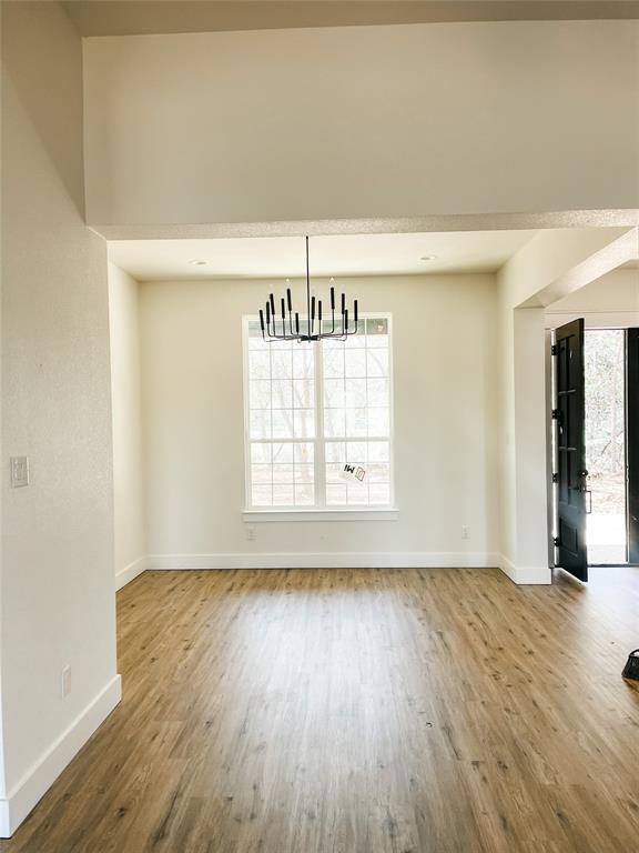 4072 County Road Cleburne, TX 76031 - Photo 4 of 20 an empty room with wooden floor and windows