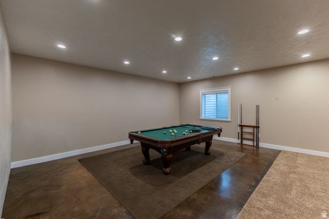 3565 West 1350th Street North Vernal, UT 84078 - Photo 43 of 54 Recreation room featuring recessed lighting, a window with horizontal blinds, and a blend of concrete and carpet flooring