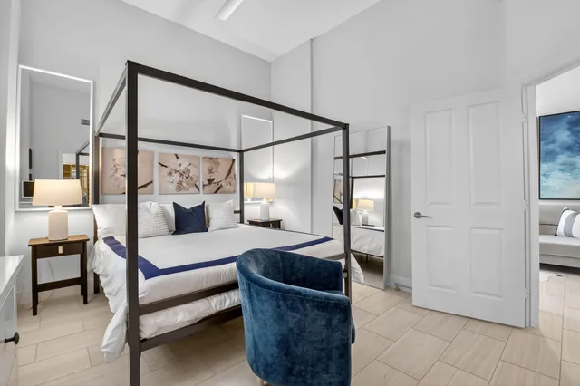 a bedroom with a bed a couch and dresser