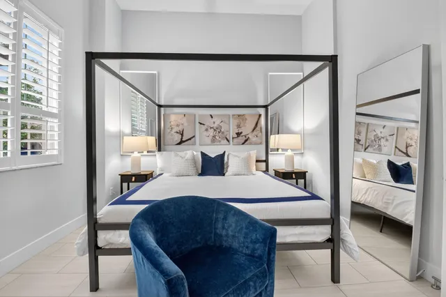 a bedroom with a bed and a mirror