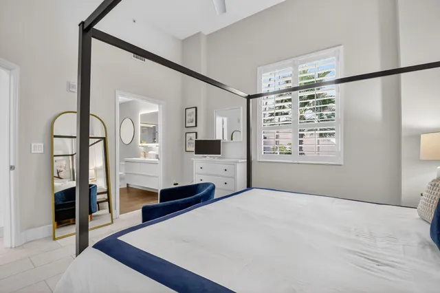 a bedroom with a large bed and a window