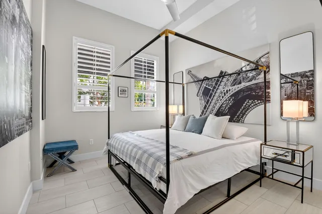 a patio with a table and chairs and potted plants