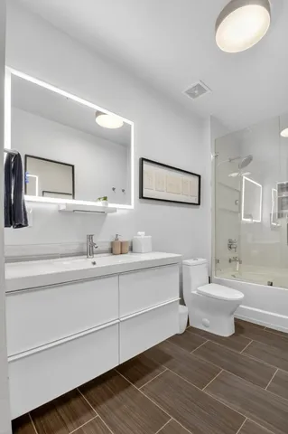 a living room with furniture and paintings on the wall