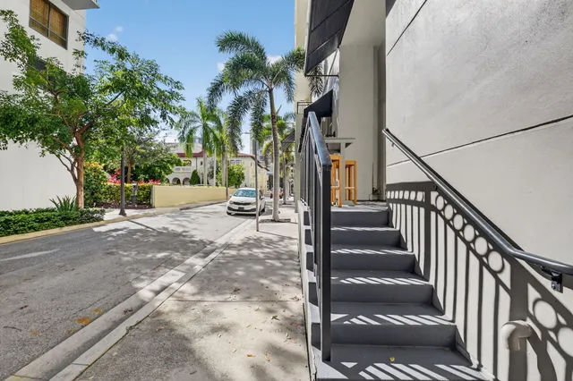 a building outdoor space with patio furniture and potted plants
