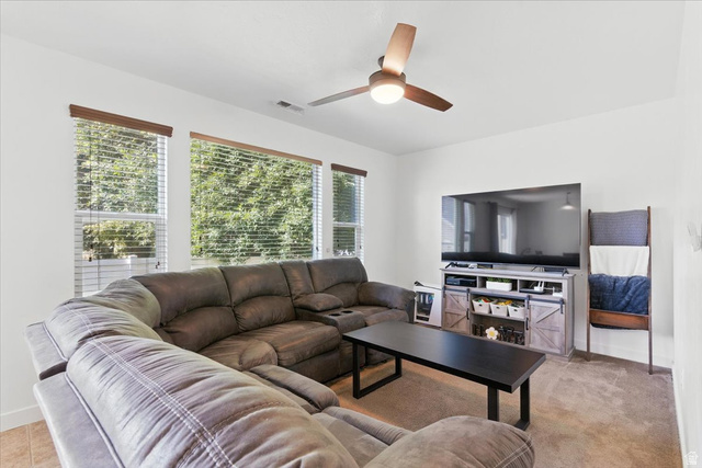 1187 Seraphim Court Layton, UT 84041 - Photo 2 of 18 Living room featuring baseboards and a ceiling fan