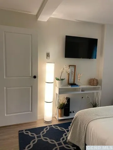 a bedroom with a bed and flat screen tv