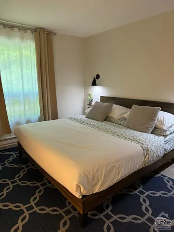 a bedroom with a bed and a window