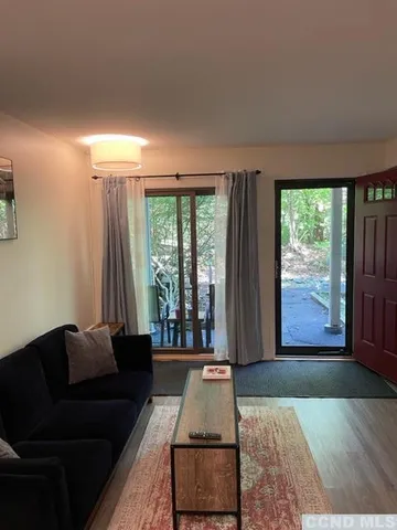 a living room with furniture and large window