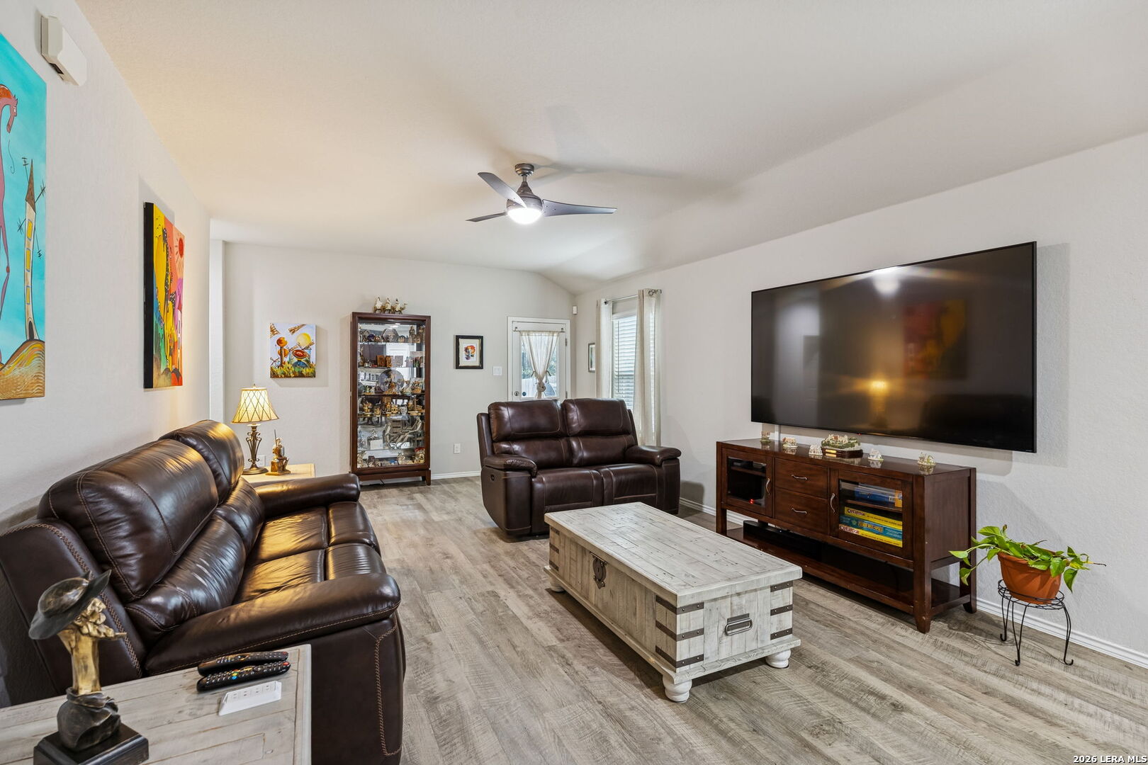 2026 Rhesus View San Antonio, TX 78245 - Photo 13 of 39 a living room with furniture and a flat screen tv