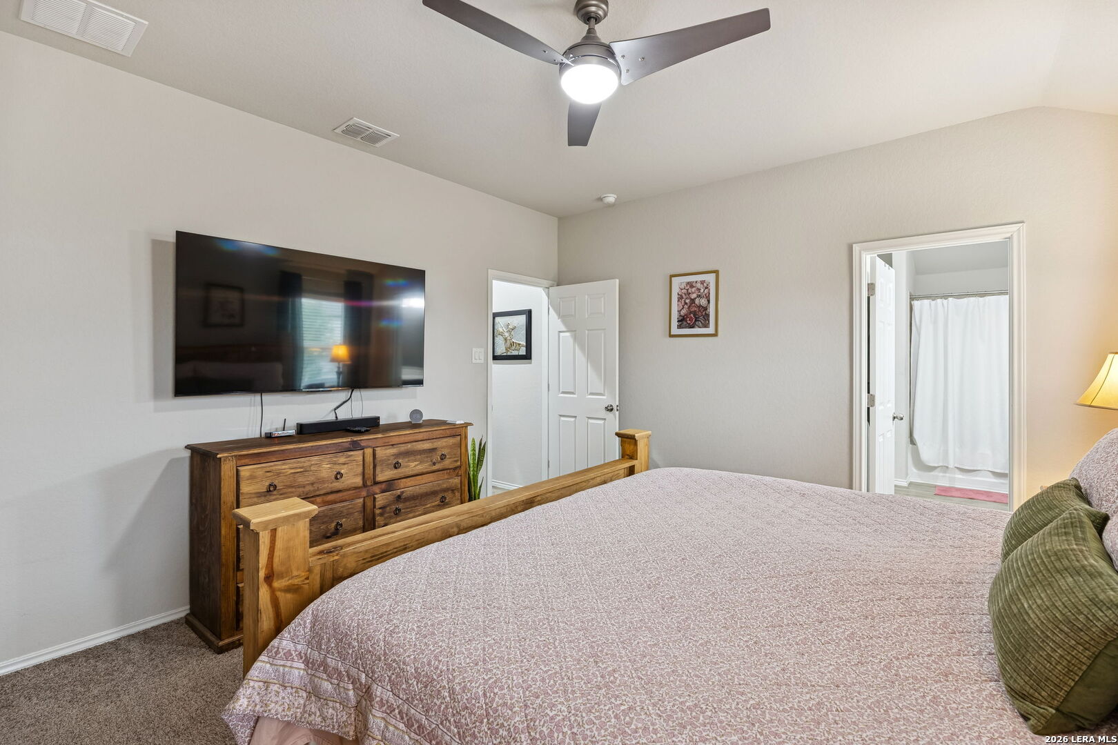 2026 Rhesus View San Antonio, TX 78245 - Photo 18 of 39 a bedroom with a flat screen television and a bed