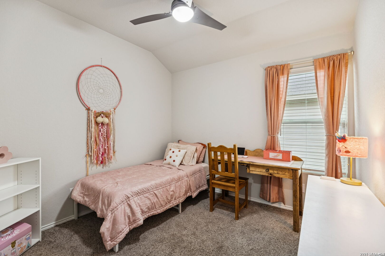 2026 Rhesus View San Antonio, TX 78245 - Photo 21 of 39 a bedroom with a bed and a chandelier