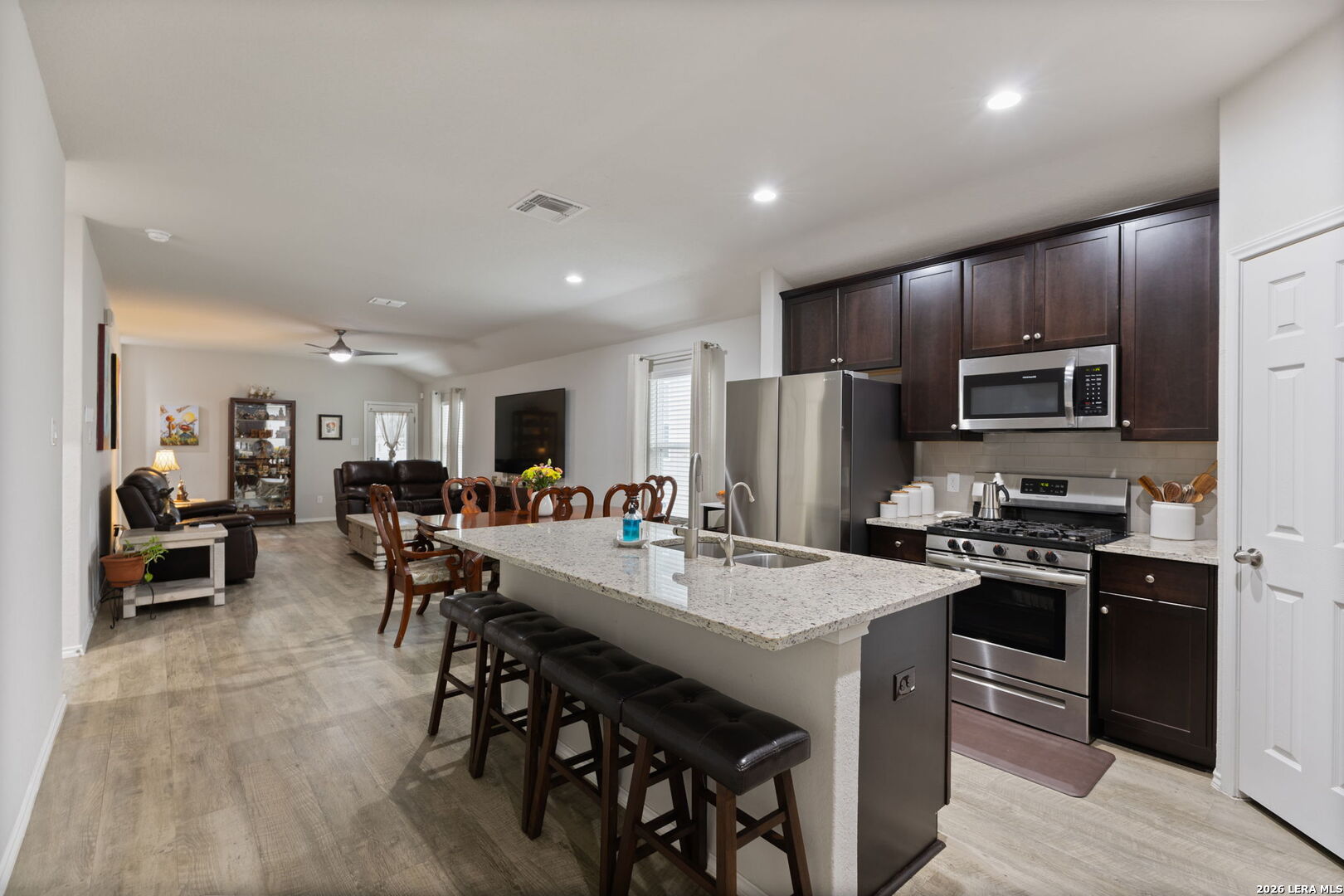 2026 Rhesus View San Antonio, TX 78245 - Photo 7 of 39 a view of kitchen with sink stainless steel appliances and dining table