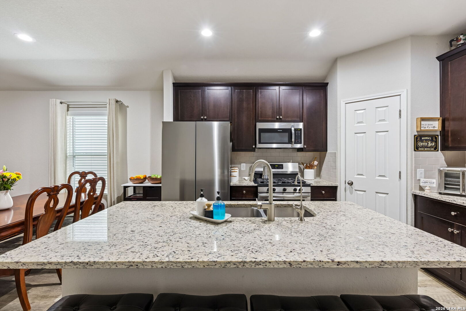 2026 Rhesus View San Antonio, TX 78245 - Photo 9 of 39 a kitchen with sink refrigerator and stove