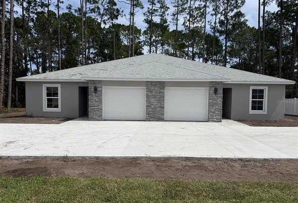 a backyard of a house with large trees