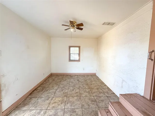 a view of a livingroom with wooden floor and a ceiling fan