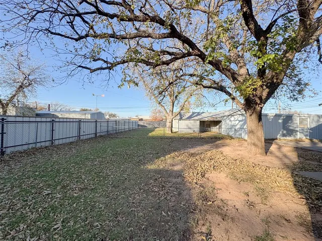 en empty room with windows and ceiling fan