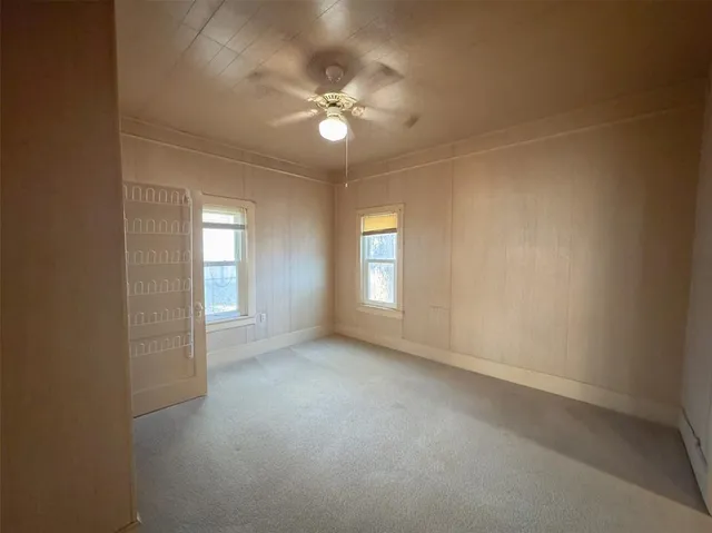 a view of a livingroom with a ceiling fan and window