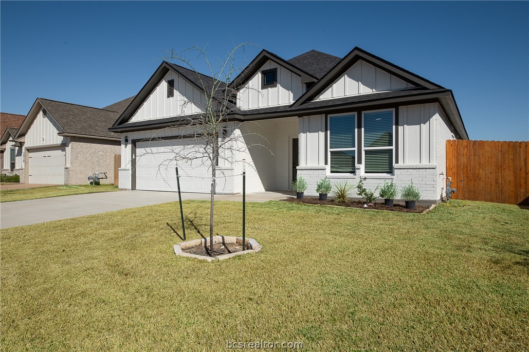 2908 GOLDBERG Drive Bryan, TX 77808 - Photo 2 of 44 Modern farmhouse style home featuring board and batten siding, brick siding, driveway, fully sodded front yard, and an attached garage