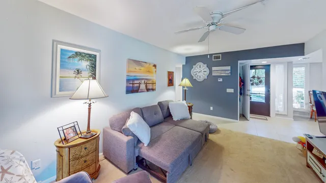 a living room with furniture and a lamp