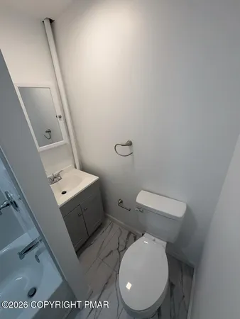 a white toilet sitting next to a white toilet