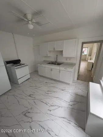 a large kitchen with cabinets and a stove