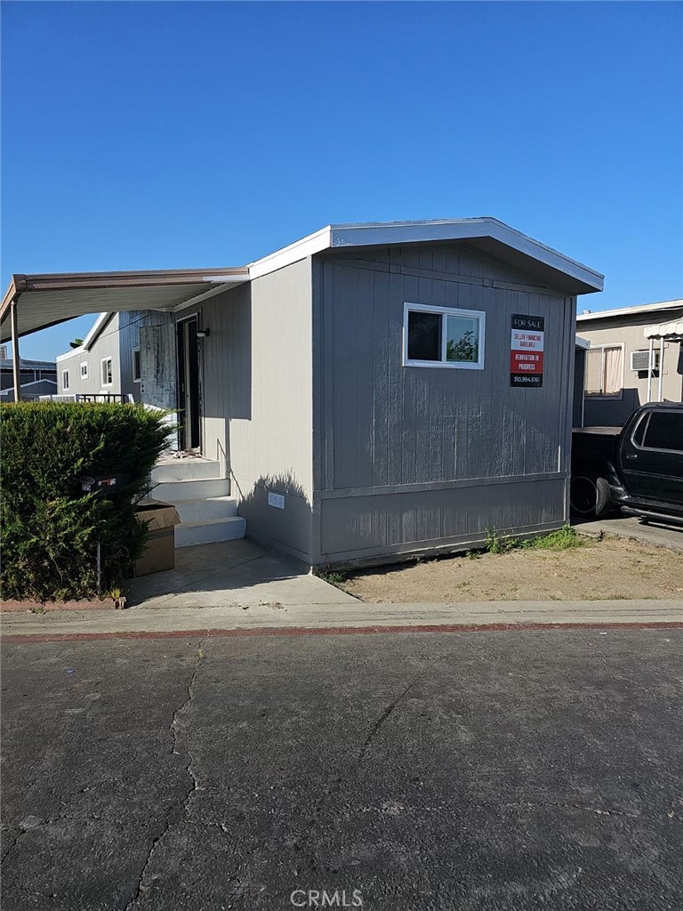 6475 Atlantic Avenue, Unit 725 Long Beach, CA 90805 - Photo 1 of 3 a front view of a house with a yard