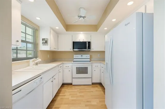 a large kitchen with stainless steel appliances granite countertop a stove and a refrigerator