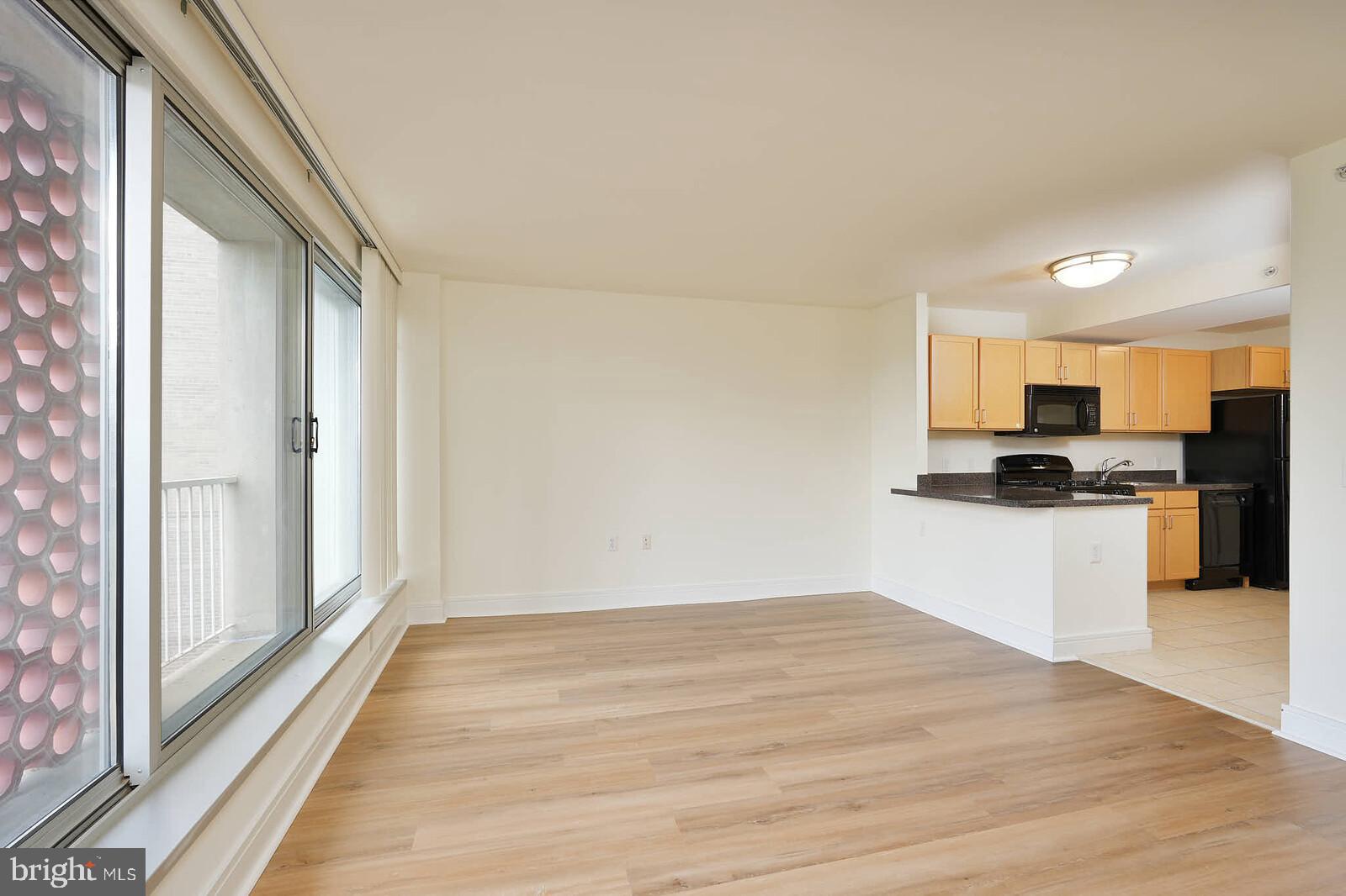800 4th Street Southwest, Unit S623 Washington, DC 20024 - Photo 11 of 49 a kitchen with granite countertop a refrigerator and a stove top oven