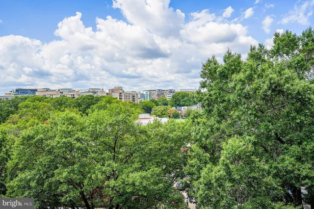 a dining hall with stainless steel appliances kitchen island granite countertop a dining table chairs and kitchen view