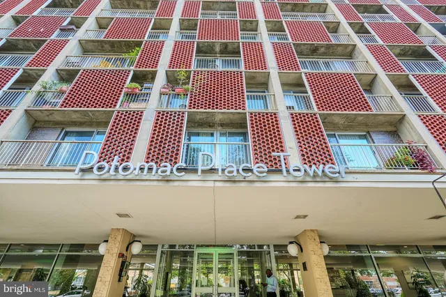 a view of a balcony with yard and outdoor seating