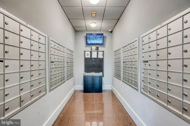 a living room with furniture gym equipment and a large window