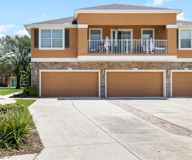 a front view of a house with a garden and garage