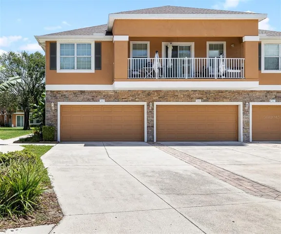 a front view of a house with a garden and garage