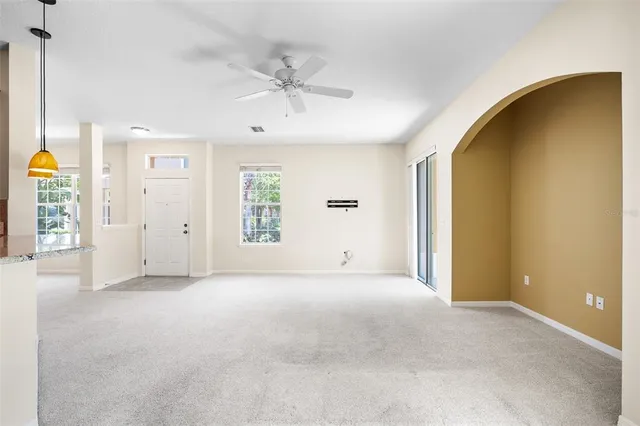 an empty room with windows and entrance