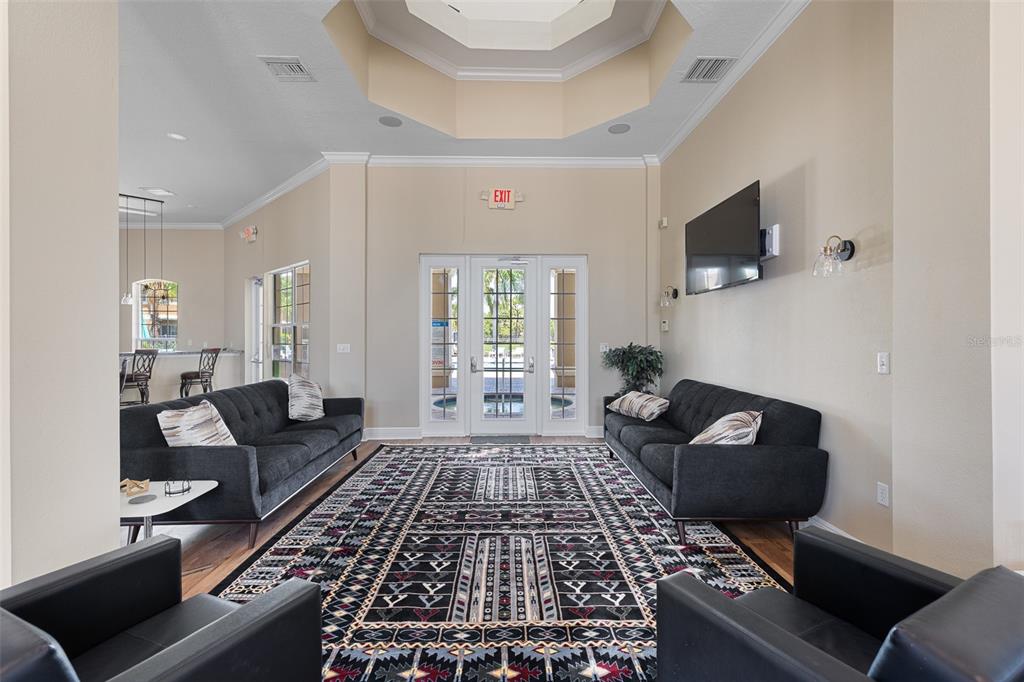 7001 Interbay Boulevard, Unit 303 Tampa, FL 33616 - Photo 33 of 37 a living room with furniture and a rug