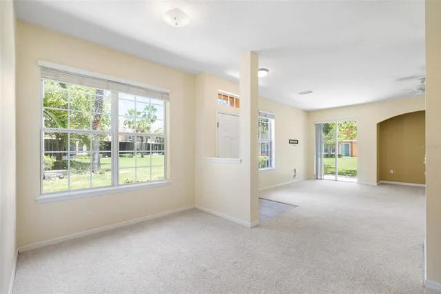 an empty room with windows and closet