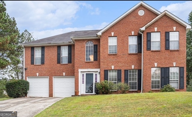 a front view of a house with a yard