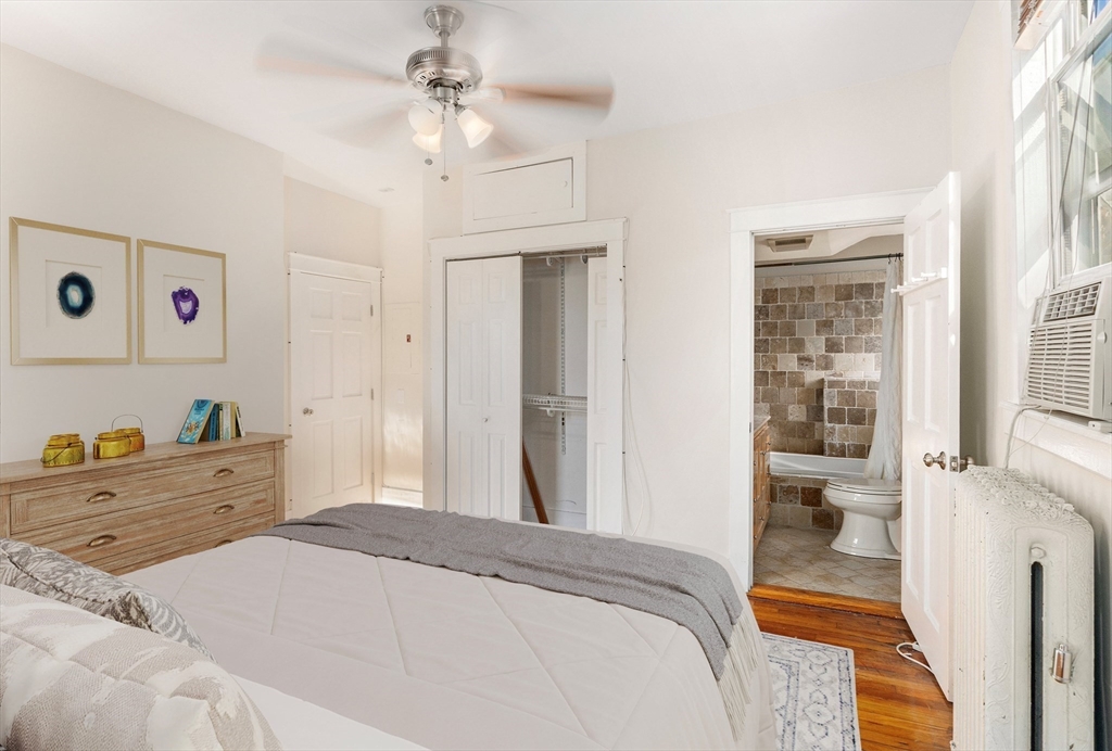 41 Worcester Square, Unit 8 Boston, MA 02118 - Photo 8 of 11 a bedroom with a bed and a chandelier