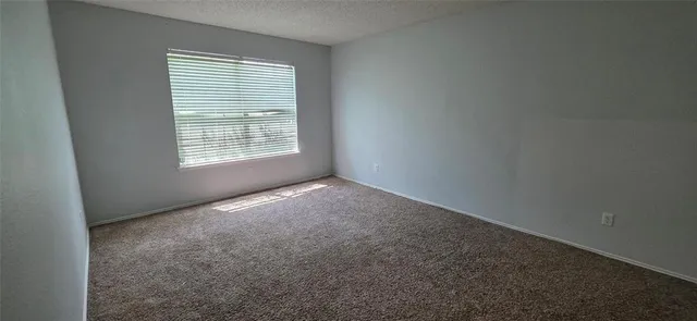 a bedroom with bed and a window