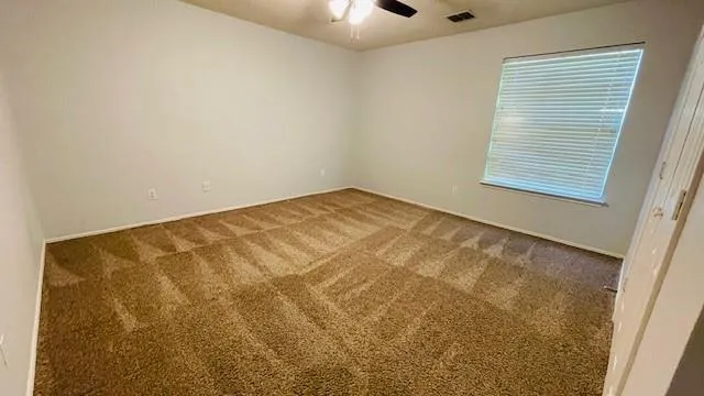 wooden floor with a large window in a kitchen