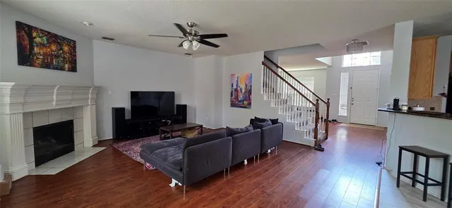 a living room with furniture fireplace and wooden floor