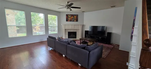 a living room with furniture a flat screen tv and a fireplace