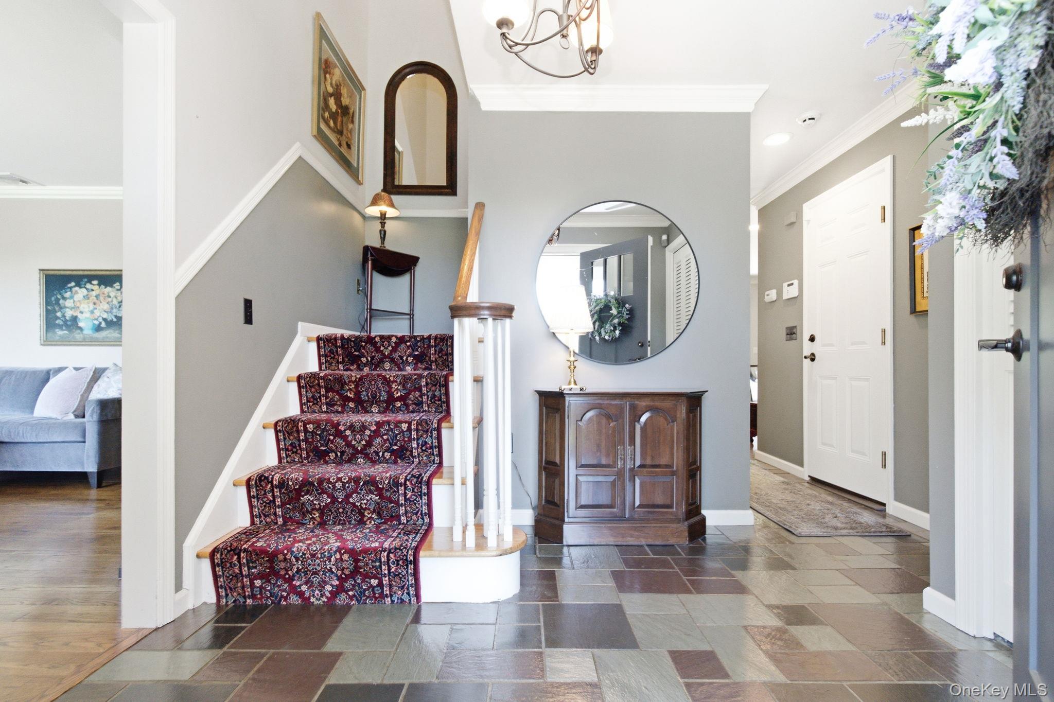 32 Bedell Road Katonah, NY 10536 - Photo 3 of 49 The slate entry foyer offers a coat closet, chandelier, and open sightlines through the main level.
