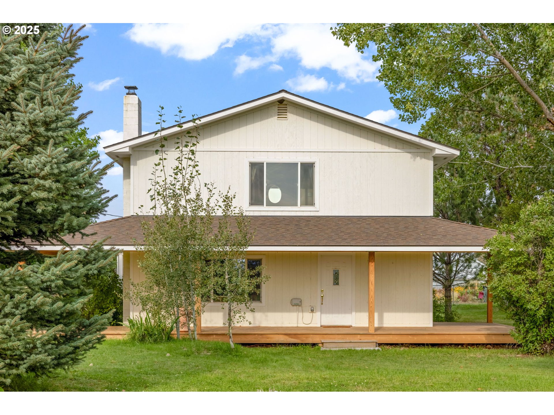 a view of a house with yard and a garden