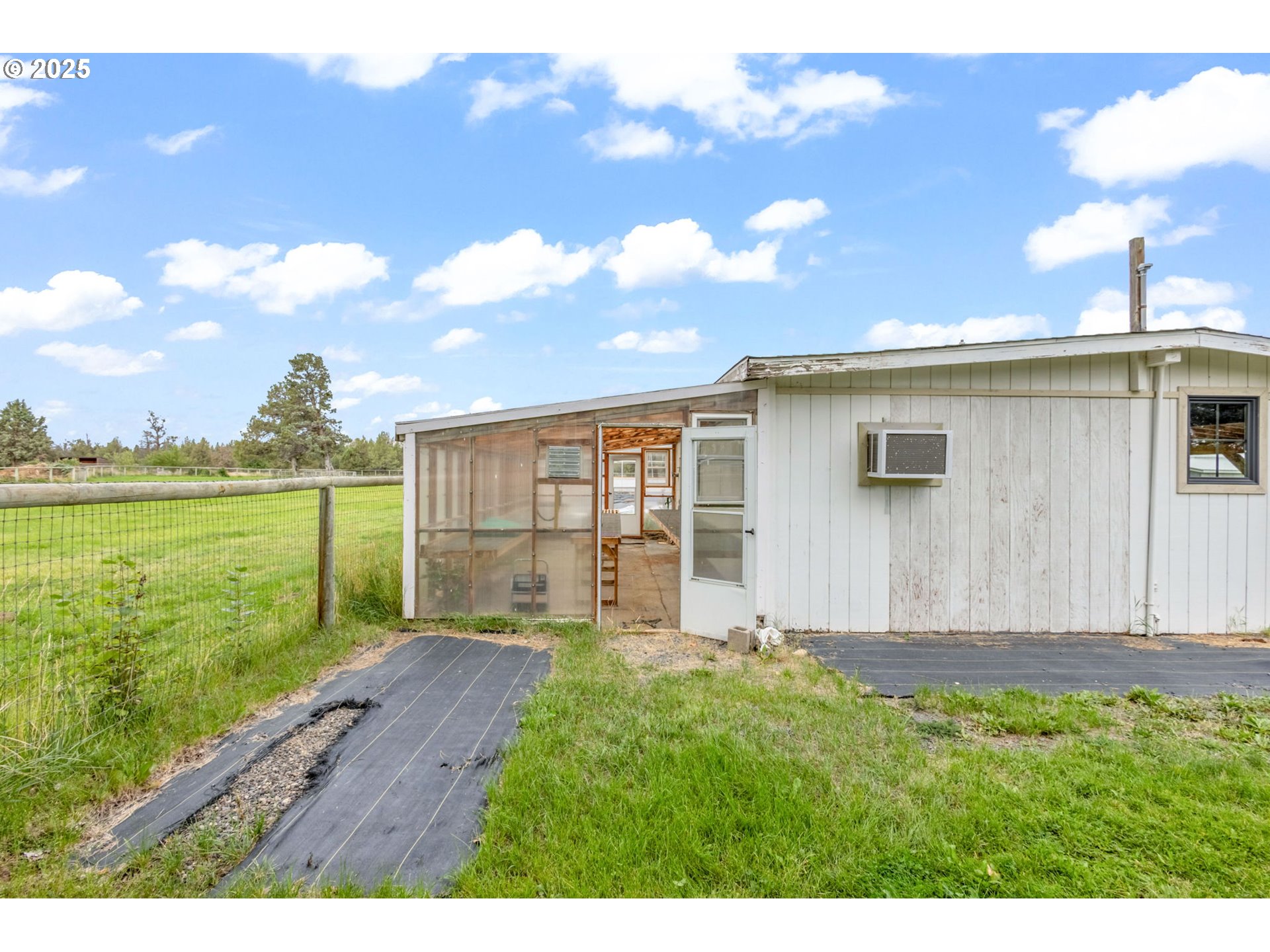 26315 Walker Road Bend, OR 97701 - Photo 34 of 45 a view of an house with backyard porch and garden