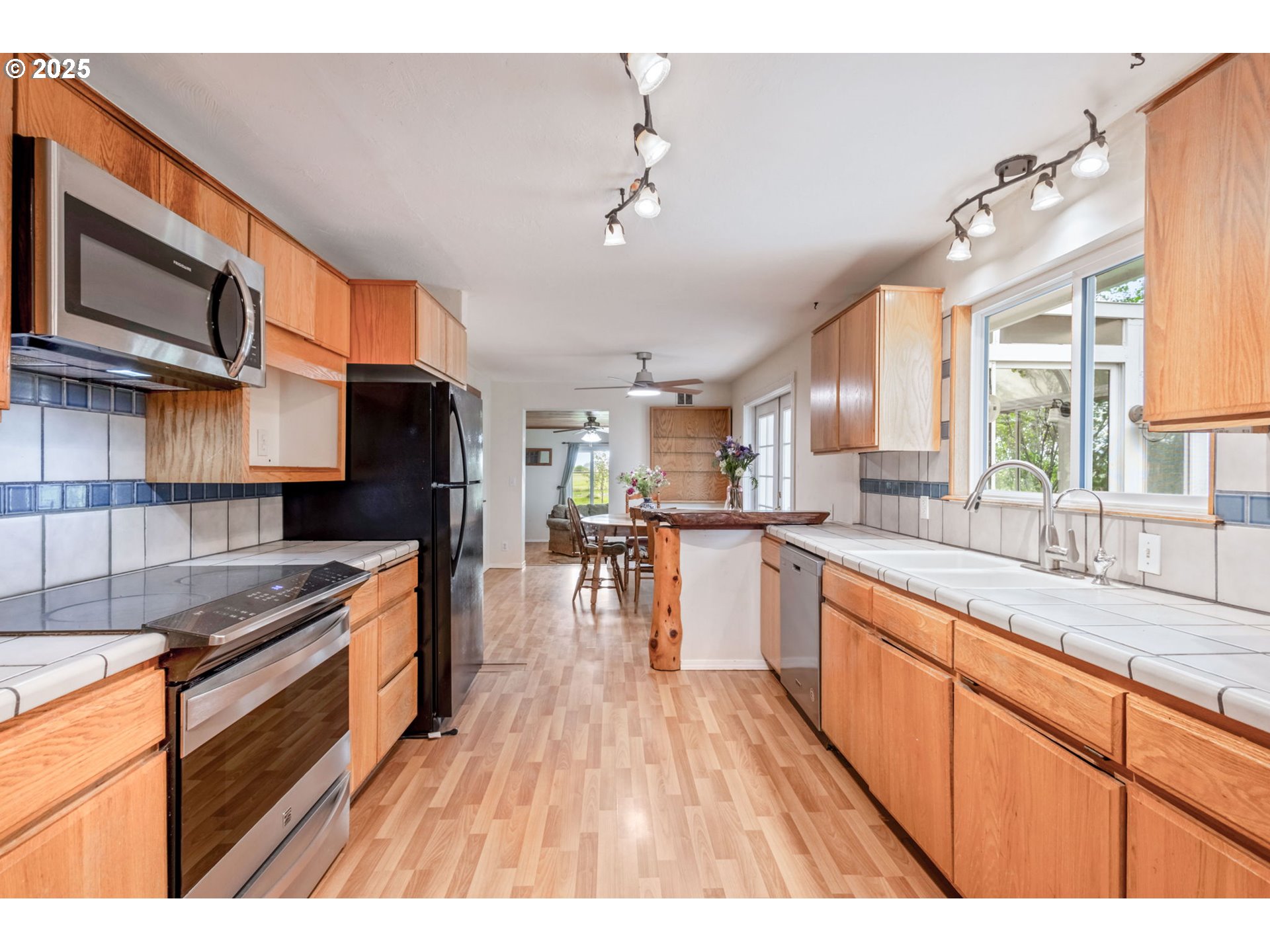 26315 Walker Road Bend, OR 97701 - Photo 5 of 45 a kitchen with stainless steel appliances granite countertop a refrigerator a sink dishwasher a stove and white countertops with wooden floor